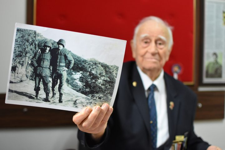 عثمان يسار إكين يظهر صورة له (يمينًا) مع زميل جندي في عام 1953 أثناء الحرب الكورية.