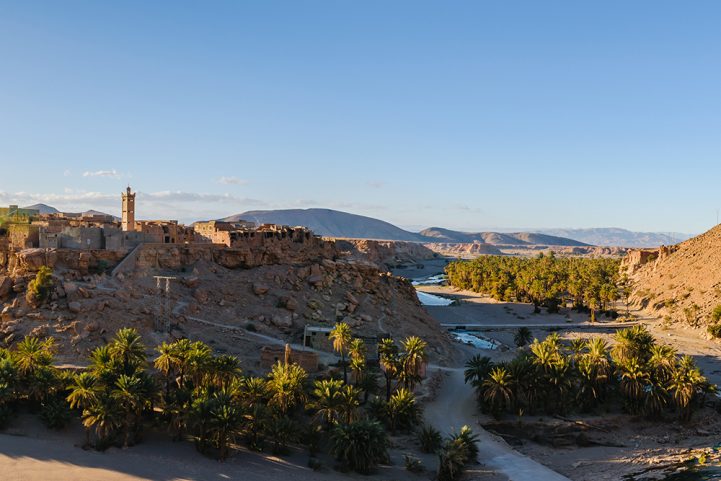 نهر Oued n'Fis عبر بلدة صغيرة في الأطلس الكبير/ Istock