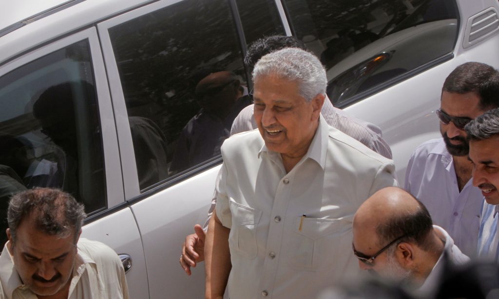 العالم النووي الباكستاني الراحل عبد القدير خان محاطاً برجال أمن مختصين بحمايته/ رويترز