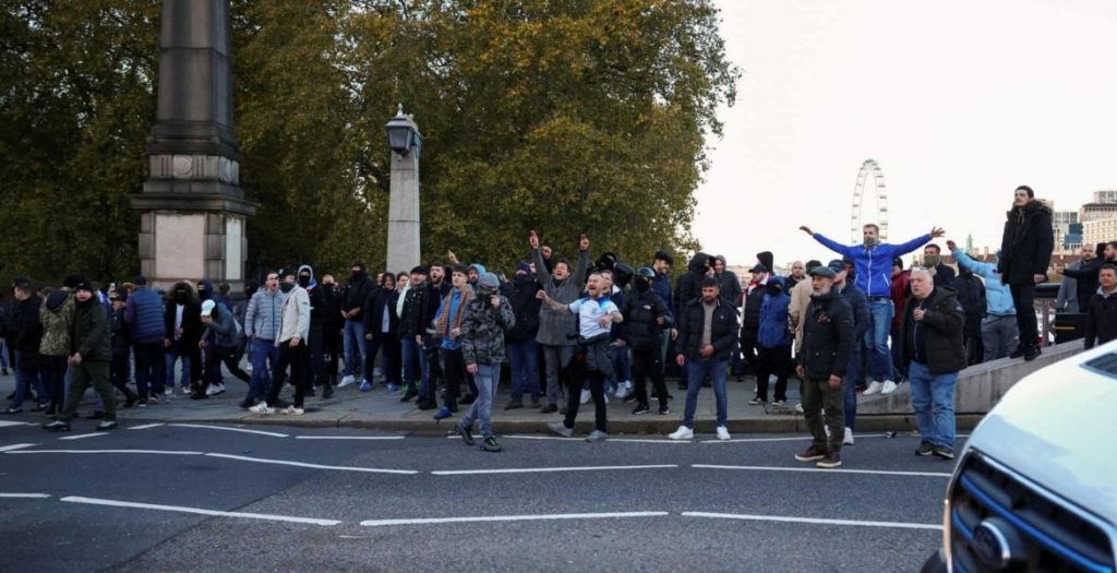 متظاهرون من اليمين البريطاني مناهضون يسخرون من الشرطة عند وصولهم إلى لندن بأعداد كبيرة لتفريق مظاهرة مؤيدة للفلسطينيين في نوفمبر/تشرين الثاني-رويترز